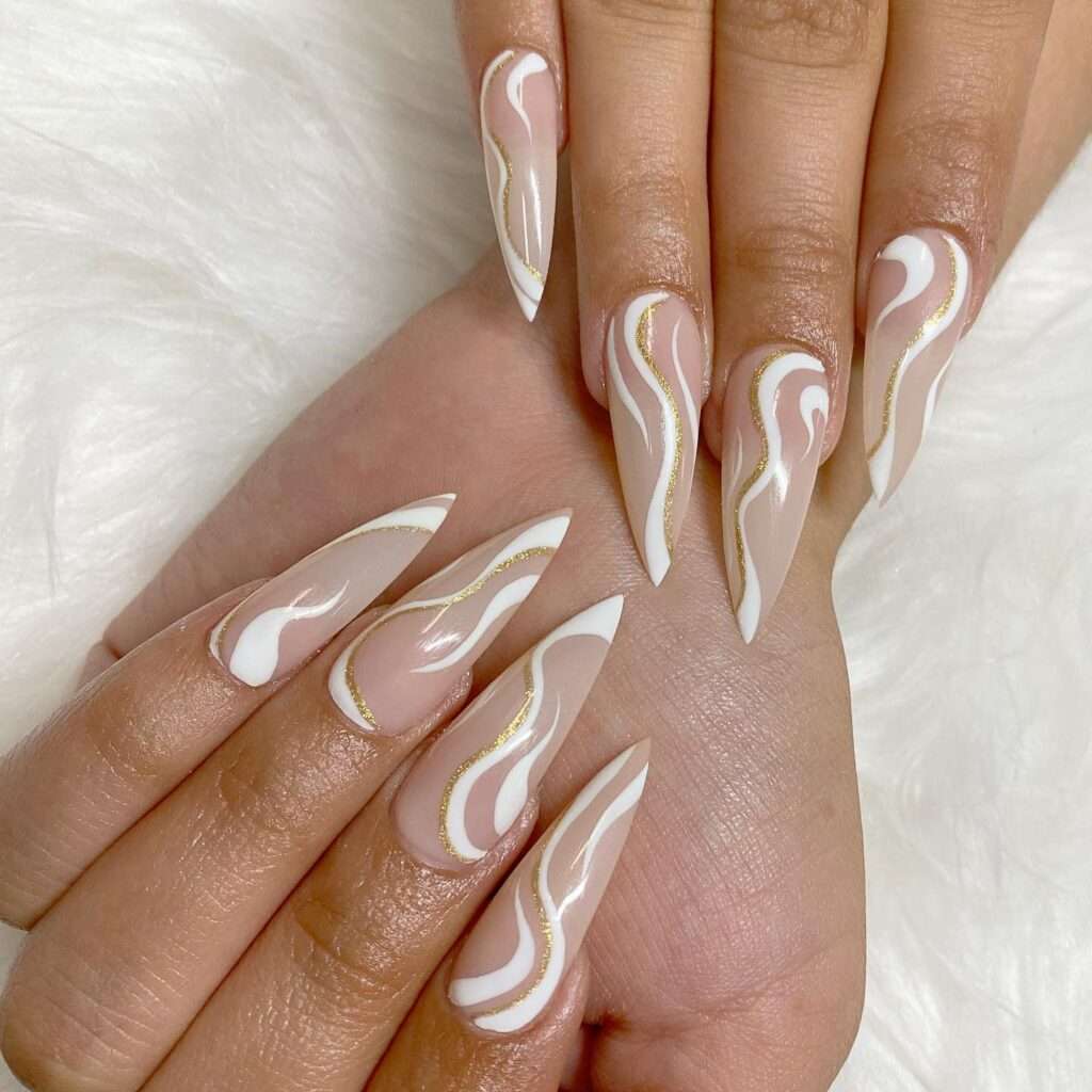 white and gold swirl nail design